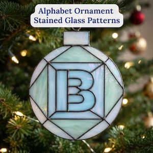 May include: A circular stained glass ornament featuring the letter B in the centre, constructed with iridescent light blue and pale green glass panels joined by dark metal solder lines. The text Alphabet Ornament Stained Glass Patterns is visible.