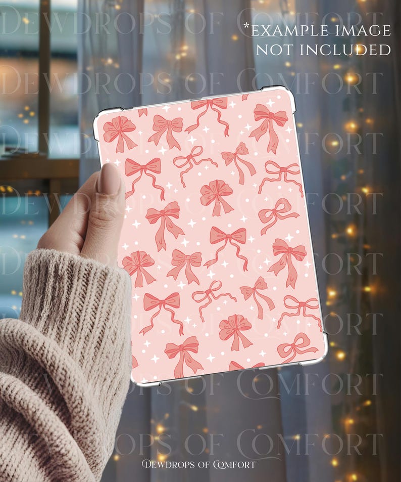 May include: A pink tablet case featuring a pattern of red bows and white star shapes. The text "EXAMPLE IMAGE NOT INCLUDED" is visible. The case is held in a hand, with the brand name "DEWDROPS OF COMFORT" at the bottom.