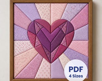 May include: A square wall art piece featuring a central heart made of various shades of purple and pink fabric segments. The heart is surrounded by a sunburst pattern of light pink and lavender fabric panels, all enclosed in a wooden frame.
