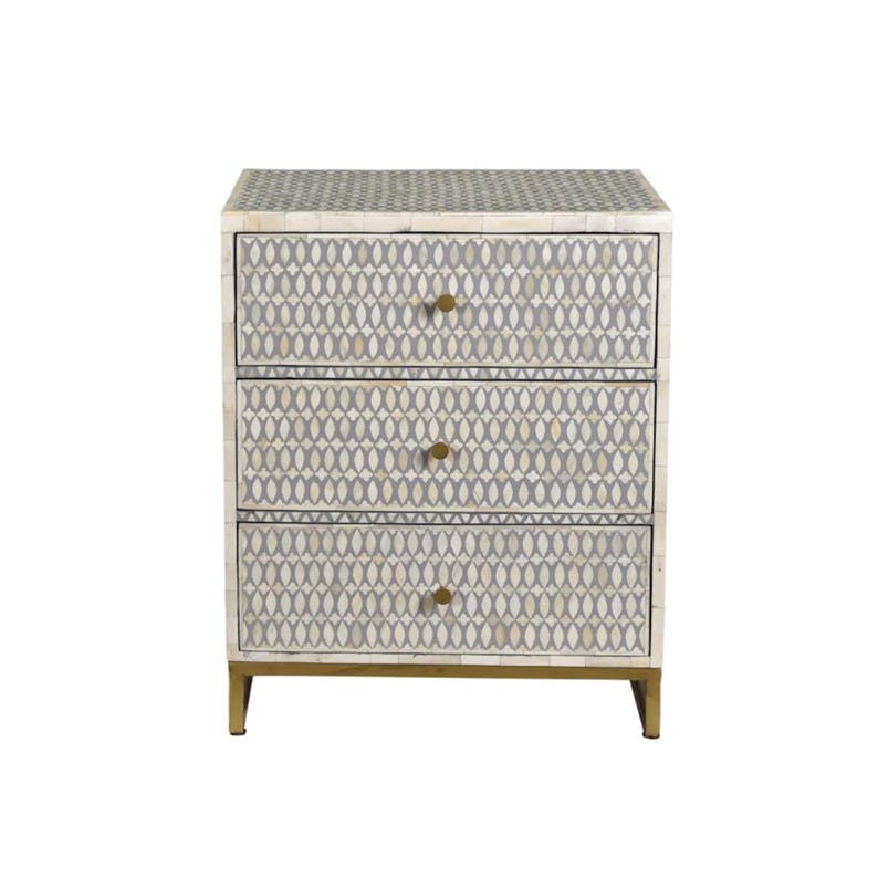 May include: A three-drawer nightstand with a geometric pattern in gray and cream. The cabinet has gold-colored hardware and legs. The drawers are adorned with a repeating oval design. A stylish piece of bedroom furniture.