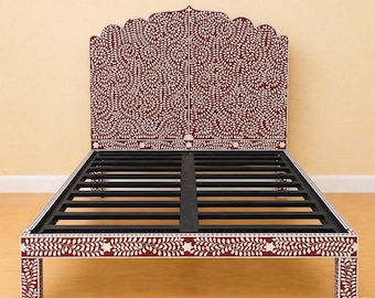 May include: A maroon and white bed frame with a decorative headboard. The headboard and frame feature a white leaf and floral pattern. The bed frame has a black metal support structure and is designed for a standard mattress.