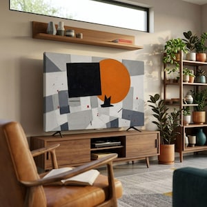 May include: A flat-screen television displaying an abstract painting with a large orange circle, a black square, and geometric gray shapes. The television sits on a wooden media console with open shelving and cabinets, positioned below a floating wall shelf.