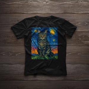 May include: Black t-shirt featuring a seated cat with a starry night background. The cat has yellow eyes and a striped pattern. The background has swirling blue, yellow, and orange colors, reminiscent of Van Gogh's style.
