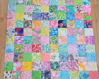 Throw size quilt measuring 50"×60" made by me with authentic vintage Lilly fabrics.