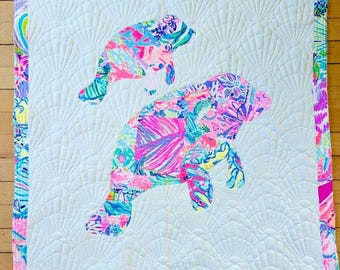 Super sweet mama and baby manatee quilt made with authentic fabric.   This quilt is made by me and measures 32"×36".
