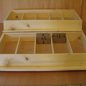 May include: Two wooden boxes with dividers, one stacked on top of the other. The top box has six dividers and the bottom box has five dividers. The dividers are labeled with fractions: 2 1/2 and 3 1/2.