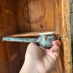 May include: A handmade wooden sign with the text "Welcome to our home" in a handwritten style. The sign is painted white with a dark stained frame. A small, decorative heart is in the lower right corner.