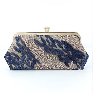 May include: A rectangular clutch with a gold-tone frame and clasp. The clutch features a beige mesh overlay embroidered with blue and light pink leaf-like patterns. A small, clear gem is set on the clasp.