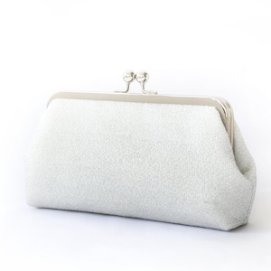 A shimmery silver clutch bag in silver mounted on a double metal frame in silver tone adorned with kisslock 2-ball clasp in the centre