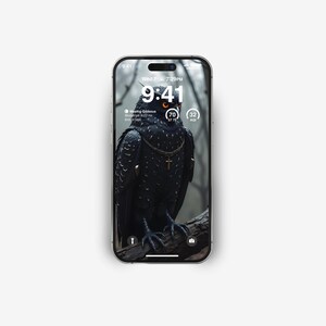 May include: A black and white phone screen displaying a dark image of an owl with a gold chain and cross. The time is 9:41 and the date is Wed 7 7:29PM. The phone screen also shows the moon phase, which is Waxing Gibbous, and the age of the moon, which is 32 days.
