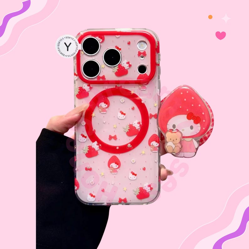 Puede incluir: Funda transparente para tel&eacute;fono con borde rojo y dise&ntilde;o de fresas y personajes. La funda tiene un agarre emergente a juego con un personaje que sostiene un osito de peluche. Dise&ntilde;ado para un tel&eacute;fono inteligente.