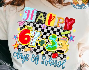 May include: A white sweatshirt with a colorful graphic design. The design features the word "HAPPY" in various colors, along with the numbers "67 + 3", a pencil, an apple, and the phrase "days of school". The background is a black and white checkered pattern.
