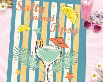 May include: A rectangular sign with the text "Salty, Tanned & Tipsy" in orange script. The sign features a margarita illustration with a lemon slice and an orange umbrella. The background has blue and yellow stripes, with star and leaf accents.