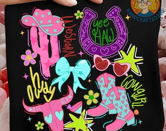 May include: Black tote bag with a colorful Western-themed design. Features a pink cowboy hat, cactus, horseshoe, heart-shaped sunglasses, cowboy boots, and a bull skull. Text includes "Yee Haw", "Howdy", "Western", and "Cowgirl".