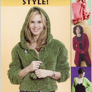 May include: A green hooded sweater with a zip fastening and a textured knit. The sweater is styled with blue jeans. The image also shows three other sweaters in different colours and styles.