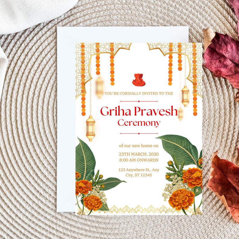 May include: A white invitation card with gold and orange accents. The card features a decorative archway with hanging lanterns and floral accents. The text reads "YOU'RE CORDIALLY INVITED TO THE Griha Pravesh Ceremony of our new home on 23TH MARCH, 2030 8:00 AM ONWARDS 123 Anywhere St., Any City, ST 12345".