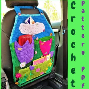 May include: A blue, green, and purple crochet car seat organizer featuring multiple pockets, floral and butterfly appliques, and the text CROCHET PATTERN PDF. The organizer hangs from the headrest and includes various storage compartments.
