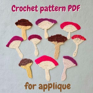 May include: A collection of ten crocheted mushroom appliques in various colours including brown, cream, pink, and red. The text "Crochet pattern PDF" appears at the top and "for applique" is at the bottom of the image, describing the items.