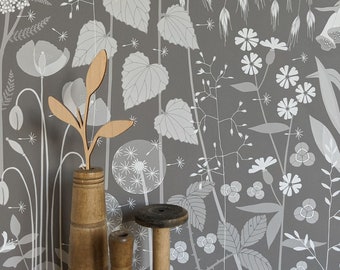 Hedgerow wallpaper in 'pipit' by Hannah Nunn, a warm brown botanical wall covering with a wild tangle of plants and flowers