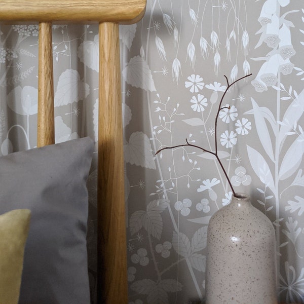 SAMPLE Hedgerow wallpaper in 'hush' by Hannah Nunn, a soft grey/pink botanical wall covering with a wild tangle of plants and flowers