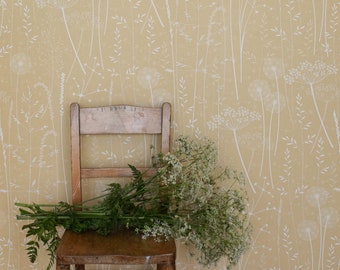 Paper Meadow wallpaper in 'harvest' by Hannah Nunn, a warm, yellow botanical wall covering with meadow seed heads and grasses