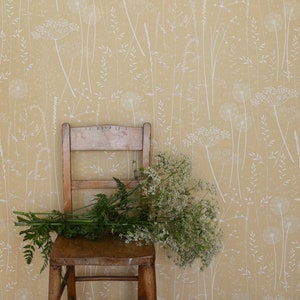 Paper Meadow wallpaper in 'harvest' by Hannah Nunn, a warm, yellow botanical wall covering with meadow seed heads and grasses