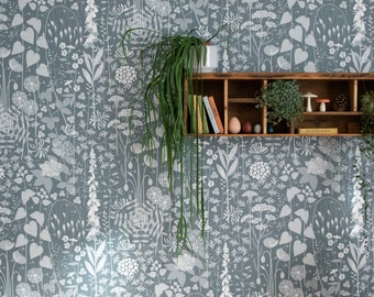 Hedgerow wallpaper in 'furling' by Hannah Nunn, a  blue/green botanical wall covering with a wild tangle of plants and flowers