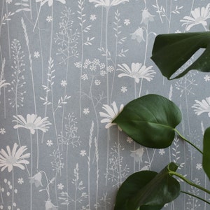 Daisy Meadow wallpaper in 'moonrise' by Hannah Nunn, a dusky blue wall covering with a summer meadow print of daisies, harebells and grasses image 1