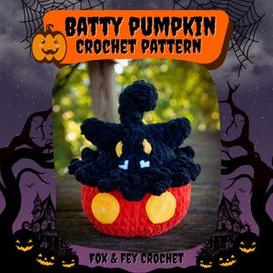 May include: A handmade crochet Batty Pumpkin, perfect for Halloween. The pumpkin is red with two yellow circles, topped with a black bat-like figure. The image includes the text "Batty Pumpkin Crochet Pattern" and "Fox & Fey Crochet".