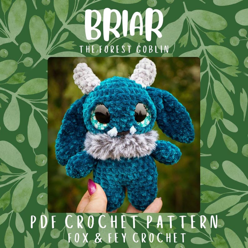 May include: A teal crochet goblin plush toy with large eyes, grey horns, and a fluffy grey collar. The image includes the text "Briar The Forest Goblin" and "PDF Crochet Pattern Fox & Fey Crochet".