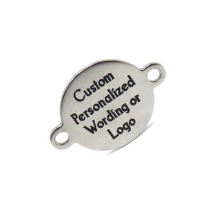 May include: Silver-toned metal tag with two holes for attaching. The tag is round with rounded edges and has the text "Custom Personalized Wording or Logo" engraved on it.