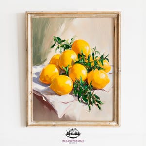 May include: A painting of a still life featuring a cluster of yellow lemons with green leaves on a white tablecloth. The lemons are arranged in a casual, organic way, with some overlapping and others spilling over the edge of the table. The painting is done in a realistic style, with visible brushstrokes and a warm color palette.