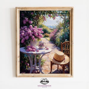 May include: A painting depicting a garden scene with a white table and chairs. A bouquet of purple flowers is arranged in a white vase on the table. A straw hat rests on one of the chairs. The garden is abundant with flowers and foliage.