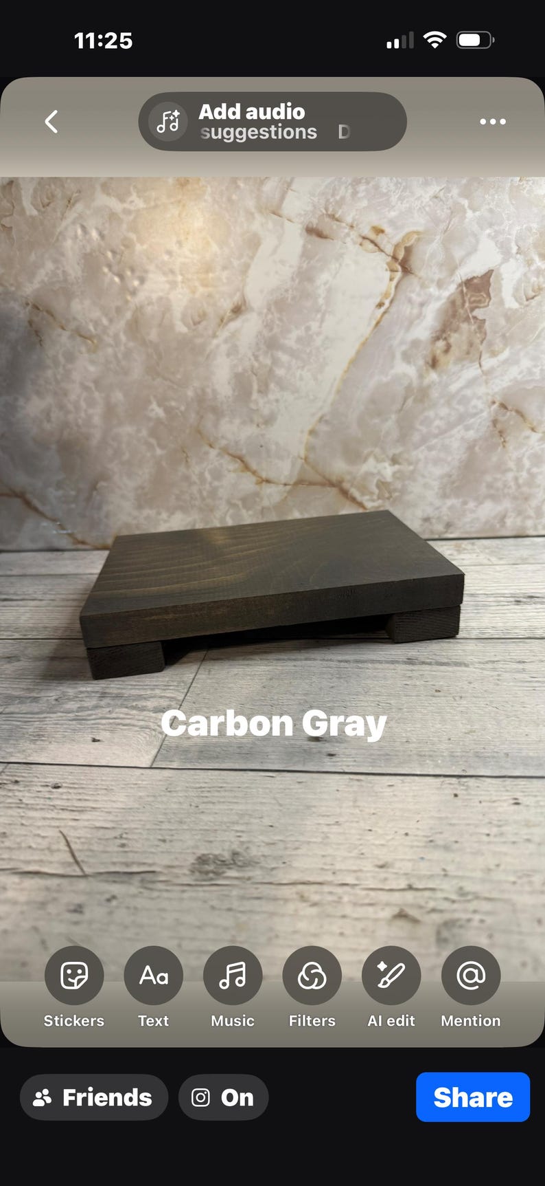 May include: A rectangular wooden riser with a dark carbon gray finish, featuring a flat top surface and four short, block-style feet. The text "Carbon Gray" is printed in white letters on the front of the wooden stand, which has a visible wood grain texture.