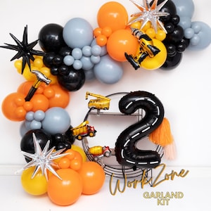 May include: A balloon garland kit featuring orange, black, gray, and yellow balloons, foil balloons shaped like a hammer, drill, construction vehicles, and starbursts, and a large black number two balloon with road markings and text Work Zone.