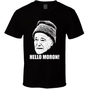 May include: Black t-shirt with a white image of a man wearing a hat and the text "HELLO MORON!"