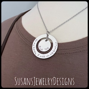 May include: A silver necklace with a double circle pendant. The outer circle says "On my honor, I will do my best..." and the inner circle says "Pack 700".