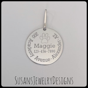 May include: Silver dog tag with engraved paw print, name Maggie, phone number 123-456-7890, address 200 Academy Avenue, Alexander, AZ.
