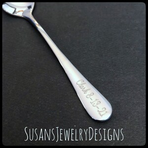 May include: A silver teaspoon with the inscription "Clark 8-13-21" engraved on the handle.
