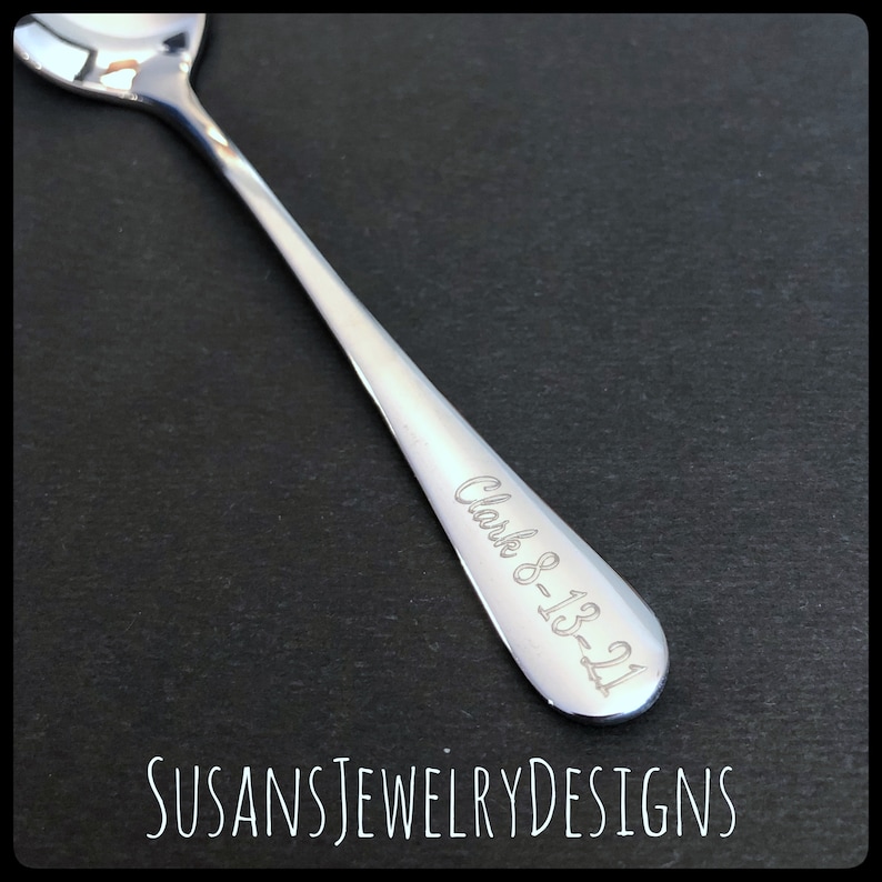 May include: A silver teaspoon with the inscription "Clark 8-13-21" engraved on the handle.
