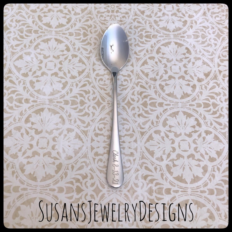 May include: A silver spoon with the date "July 8, 18-21" engraved on the handle.