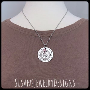 May include: A silver compass necklace with a pink crystal charm. The compass face reads "Always guide you".