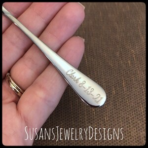 May include: A silver spoon with the inscription "Clark 8-13-21" engraved on the handle.