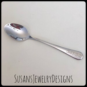 May include: A silver spoon with the inscription "Clark 8-13-21" engraved on the handle.