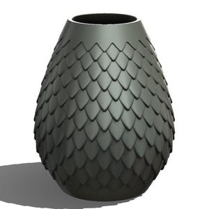 May include: A dark grey vase with a textured, scale-like pattern. The vase has a wide base that tapers to a narrower opening. The vase is approximately 25 cm tall.