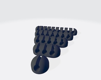 Op de afbeelding: Een groep zwarte kabelorganisatoren in een driehoekige vorm. De organisatoren zijn gemaakt van flexibel plastic en hebben een klein gat in het midden om kabels vast te houden.