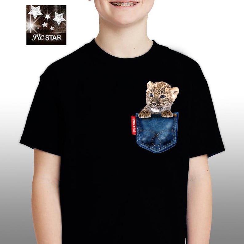 May include: Black t-shirt with a blue denim pocket. A small leopard cub is peeking out of the pocket.