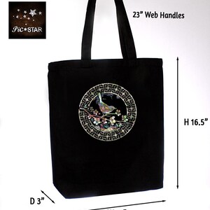 May include: Black canvas tote bag with a circular design featuring a bird on a branch with flowers. The design is made of iridescent shell pieces. The bag has 23 inch web handles and measures 15 inches wide, 16.5 inches high, and 3 inches deep.