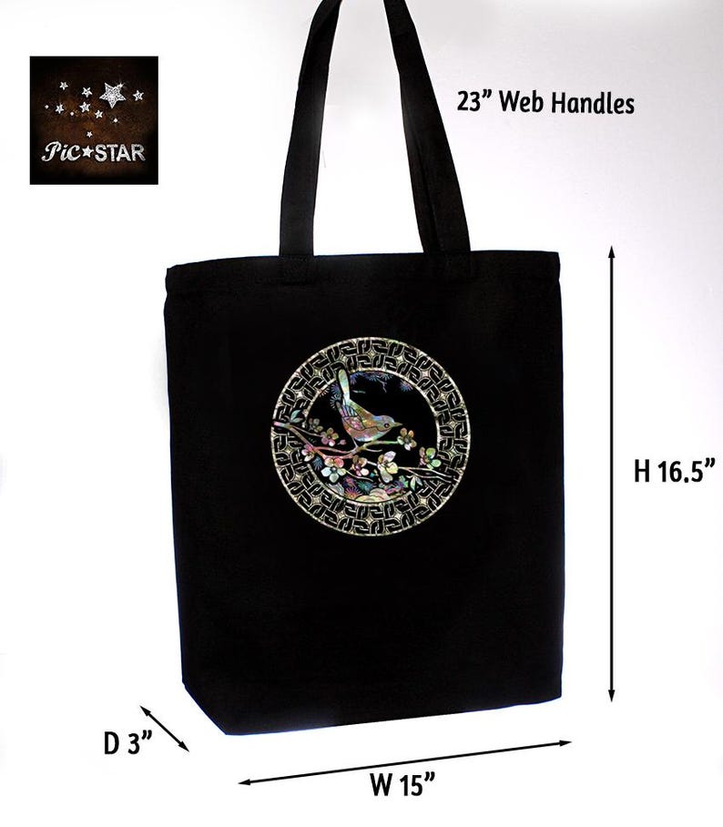 May include: Black canvas tote bag with a circular design featuring a bird on a branch with flowers. The design is made of iridescent shell pieces. The bag has 23 inch web handles and measures 15 inches wide, 16.5 inches high, and 3 inches deep.