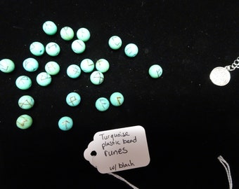 Turquoise plastic bead runes with black ink